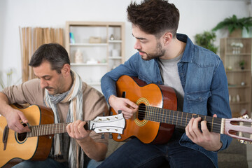 two men jamming with guitars