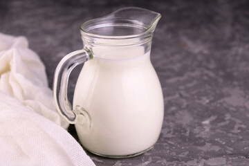 
Milk in a decanter on a gray background.Copy space.
