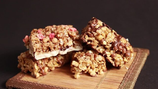 Protein bars with muesli and nuts on a dark background. Close-up, selective shot.