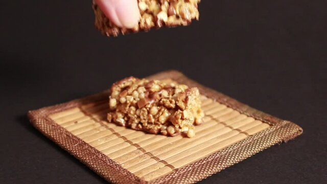 Protein bars with muesli and nuts on a dark background. Close-up, selective shot.