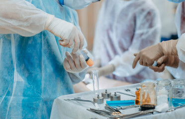 preparation of fat cells for lipofilling in the operating room. Surgical cosmetic surgery to rejuvenate the face with the introduction of stem and fat cells.