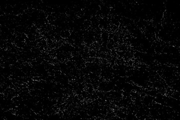 White dust on a black surface. View from above. Macrophotography.