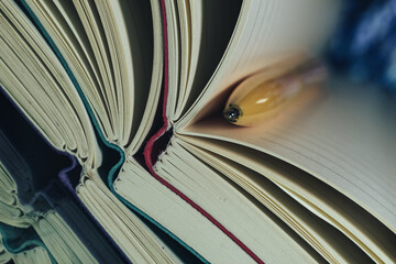 Close up beautiful notebook and pen on a multi colored background.