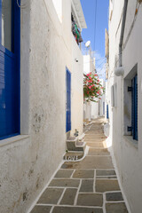 Fototapeta na wymiar A narrow street in the old town of Chora. The inscription on the stairs in English: Love. Ios Island. Greece