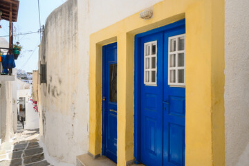Blue doors on street in the old town of Chora, the capital of Ios Island. Traditional Cycladic architecture . Greece