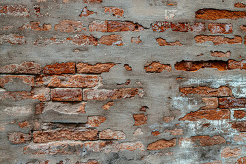 Old brick wall with cracks and scratches, brick background, pattern. Old brick wall with cracks and scratches. Vintage house facade. Background of old vintage brick wall. texture, grunge 