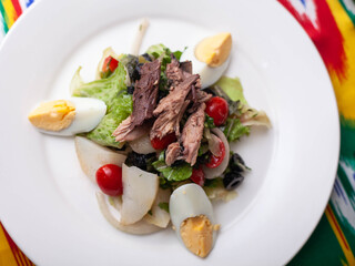 Salad with tuna. Salad with eggs, herbs, onions, cherry tomatoes, and tuna. Asian style