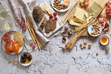 Appetizers table with various of cheese, curred meat, sausage, olives, nuts and fruits. Festive...