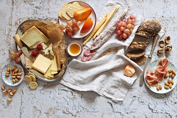 Appetizers table with various of cheese, curred meat, sausage, olives, nuts and fruits. Festive...
