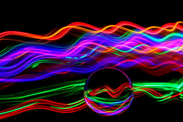 Long exposure photograph of neon multi colour in an abstract swirl, parallel lines pattern against...