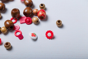 Close up shot of beads and buttons for sewing and embroidery. Brown and red set of materials for handcraft, making of bijouterie and accessories. Copy space.