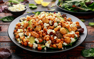 Roasted Cauliflower salad with chickpea, cucumber, greens and feta cheese. healthy food