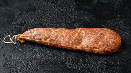 Dry cured pork meat salami in natural skin casing