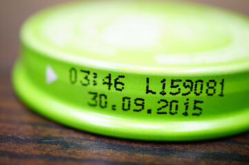 Closeup shot of a baby food jar lid with an expiration date