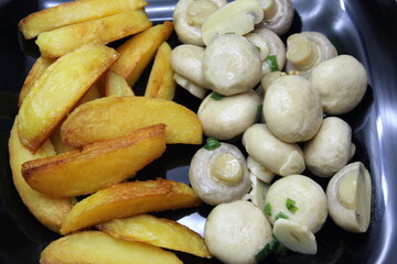 Pickled mushrooms champignons with potatoes in a plate