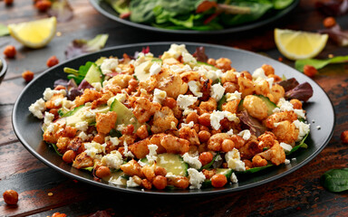 Roasted Cauliflower salad with chickpea, cucumber, greens and feta cheese. healthy food