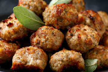 Pork stuffing meatballs with sage and onion in a black plate