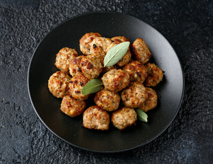 Pork stuffing meatballs with sage and onion in a black plate
