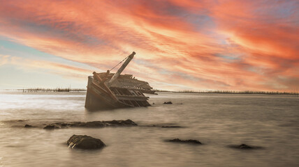 Shipwreck in Angsila Chonburi with sunset and twilight skyline..
