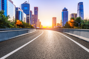 Empty asphalt road and modern cityscape in Beijing at sunset,China.