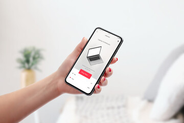 Shopping online with smart phone. Modern store app interface. Concept of purchasing tech products. Girl holding phone