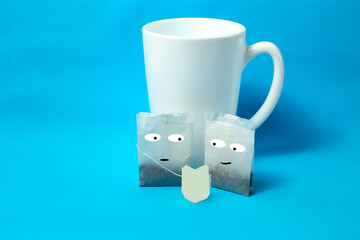Two tea bags look at the label. On a blue background