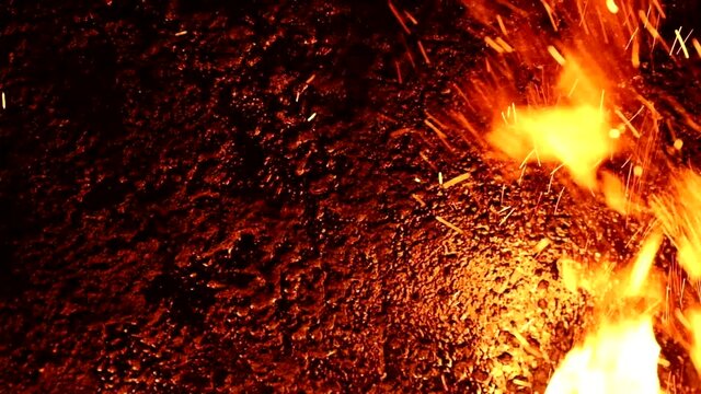 flame with sparks from burning wood in a pyrolysis boiler, bright flames