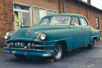Fototapeta na wymiar Rusty Classic Vintage 50s car in n need of repair