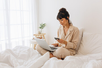 Woman making online payment using credit card