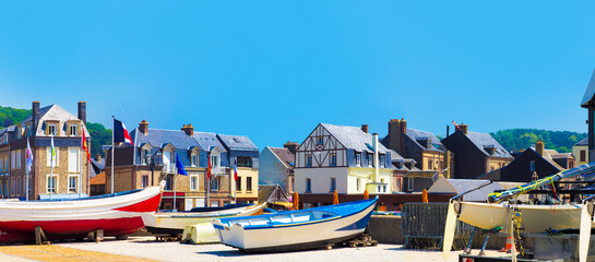 Fototapeta na wymiar Fishing boats near country houses. Picturesque panoramic landscape beautiful city of Etretat of Normandy, France