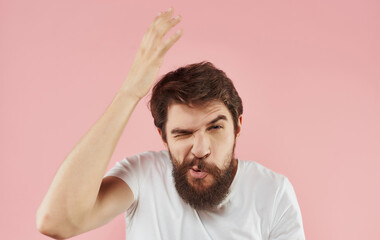 Obraz premium Bearded man emotions white t-shirt gestures with hands pink background