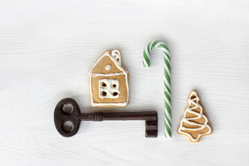 gingerbread house, ginger tree, candy staff and big retro key on the table top view. holiday...