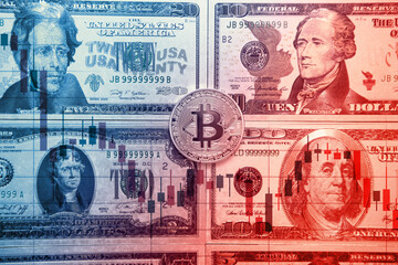 Fototapeta premium Gold bitcoins on a stack of coins with chart of growing and falling valuance of a cryptocurrency.