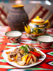  Fried beef meat in oil with potatoes, onions, bell peppers according to the Uyghur recipe