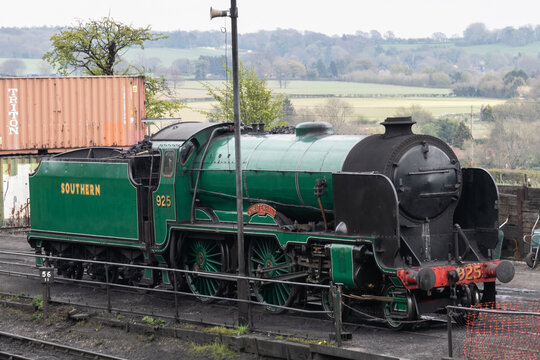 09/14/2019 Ropley, Hampshire, UK A green steam train on railway tracks