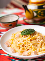 creamy pasta with chicken, basil and mushrooms, according to the Italian recipe. East style