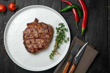 grilled steak on a white round plate.
