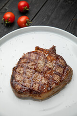 grilled steak on a white round plate.
