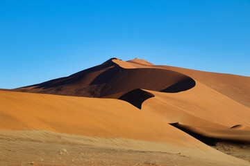 Naklejka na ściany i meble giant red sand dunes in Sossusvlei Namib Desert - Namib-Naukluft National Park, Namibia, Africa