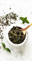 green tea leaves background in marble bowl