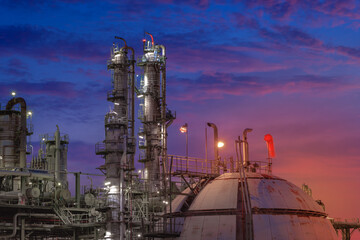 Petrochemical plant on sunset sky background with gas storage sphere tanks, Manufacturing of...