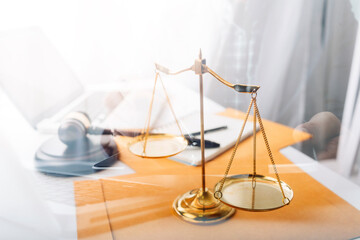 Justice and law concept.Male judge in a courtroom with the gavel, working with, computer and...