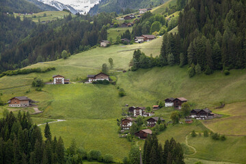 Villages located in the valley of the Alps among forests.