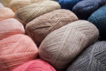 The sewing threads in gentle colors that are folded into a pile