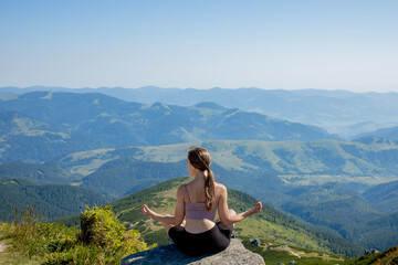Naklejka na ściany i meble Yoga, Meditation. Woman balanced, practicing meditation and zen energy yoga in mountains. Girl doing fitness exercise sport outdoors in morning. Healthy lifestyle concept.