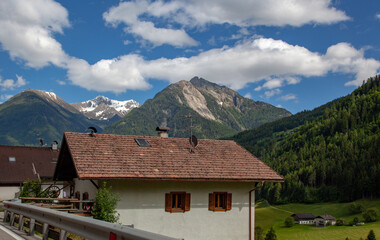 Roofs of houses against the background of the mountain peaks of the Alps.