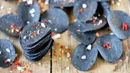  Black chips with spices on the board.