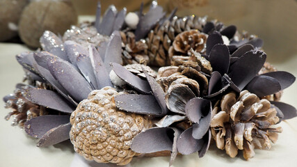 the composition of the brown cones are painted white and large grey petals for Christmas