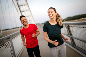 Fitness, sport, people, exercising and lifestyle concept. Couple running outdoor