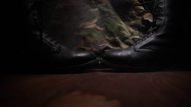 War concept. Old military shoe in a dark toned foggy background. Creative concept of conflict between countries, military aggression. Selective focus